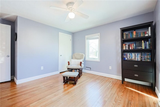 sitting room featuring light hardwood / wood-style flooring and ceiling fan