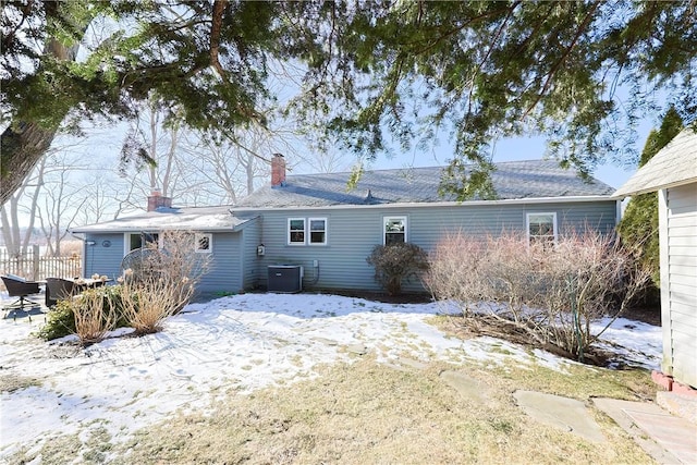 snow covered property featuring central air condition unit