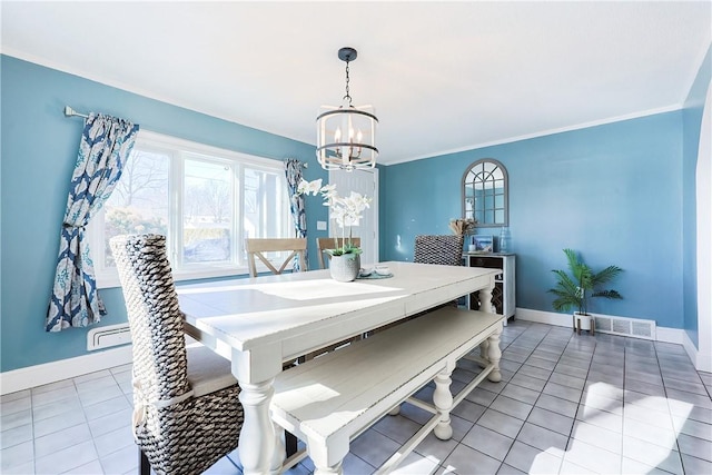 dining area featuring tile patterned flooring, ornamental molding, and an inviting chandelier