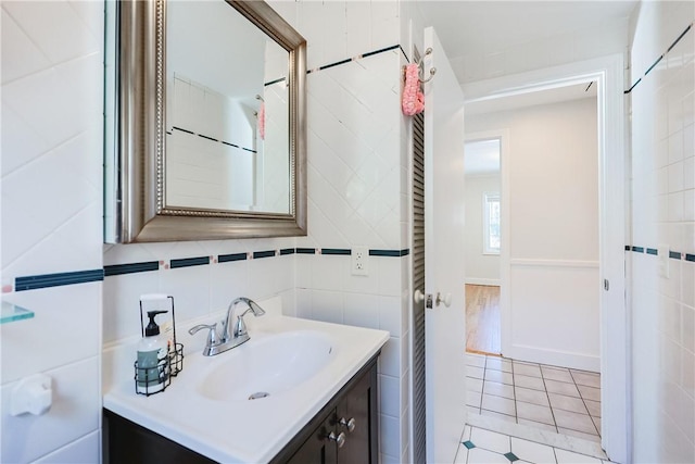 bathroom with vanity, tile patterned flooring, and tile walls