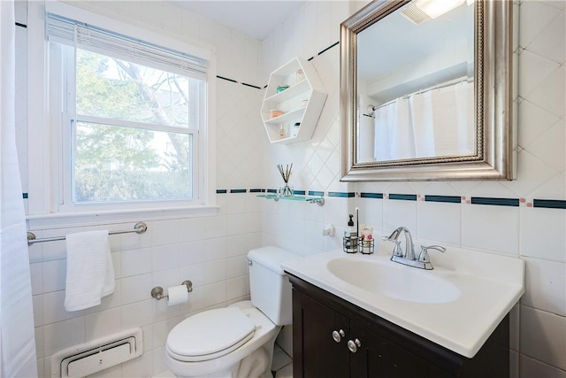 bathroom featuring vanity, tile walls, and toilet