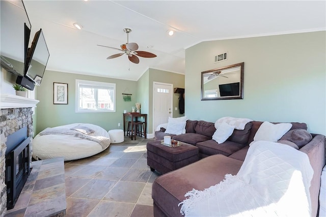 living room with a fireplace, vaulted ceiling, and ceiling fan