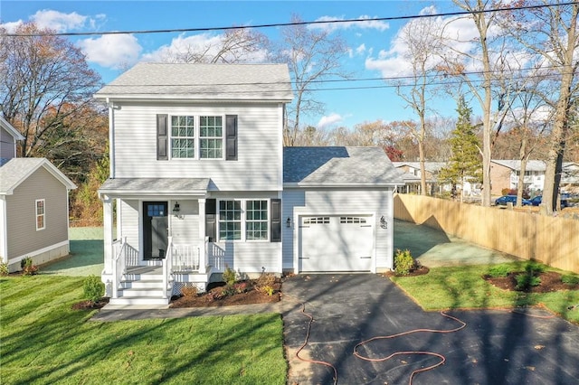 view of front property featuring a garage and a front lawn