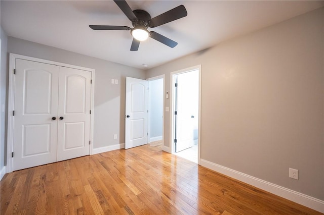 unfurnished bedroom featuring ceiling fan, light hardwood / wood-style floors, and a closet