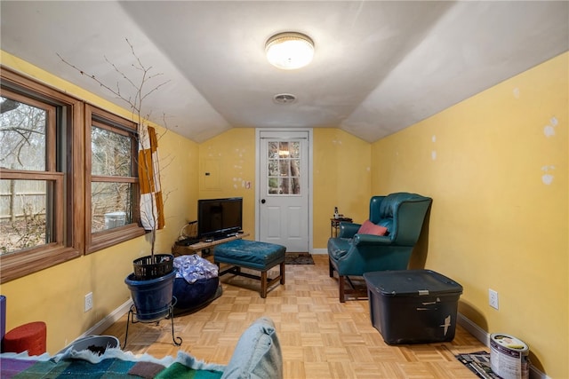 living area with vaulted ceiling and light parquet flooring