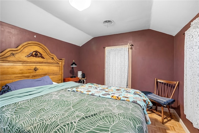 bedroom with lofted ceiling and parquet flooring