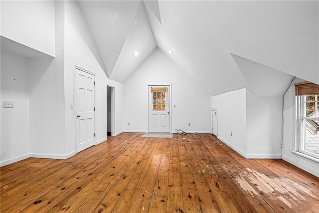 bonus room featuring wood-type flooring and vaulted ceiling