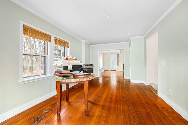 hallway with ornamental molding and wood-type flooring