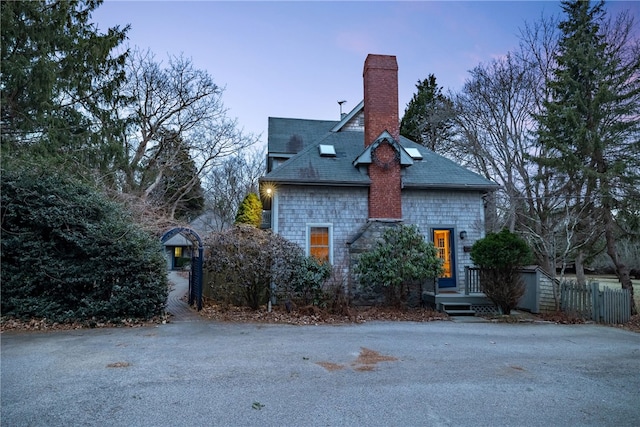 exterior space featuring fence and a chimney