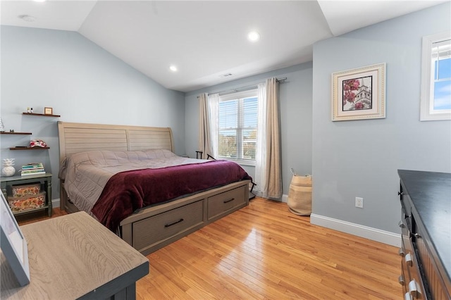 bedroom with lofted ceiling and light hardwood / wood-style flooring