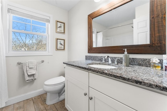 bathroom featuring hardwood / wood-style flooring, vanity, a shower with curtain, and toilet