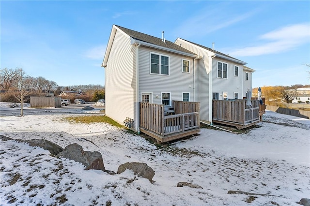 snow covered property featuring a deck