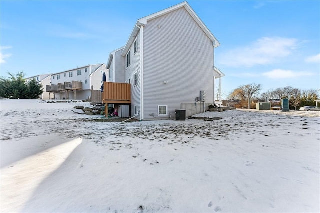 snow covered property featuring central air condition unit