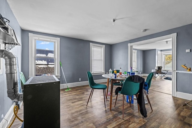 dining space featuring dark wood-type flooring