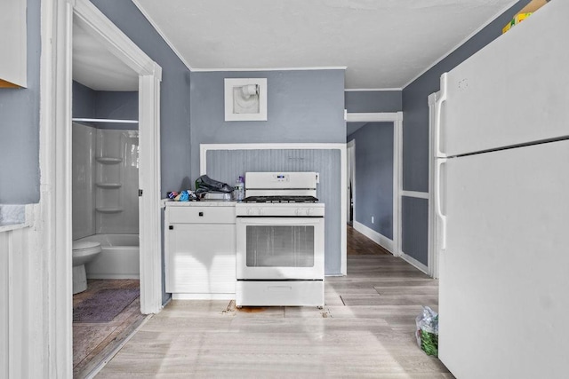 kitchen featuring white cabinetry, white appliances, and light hardwood / wood-style flooring