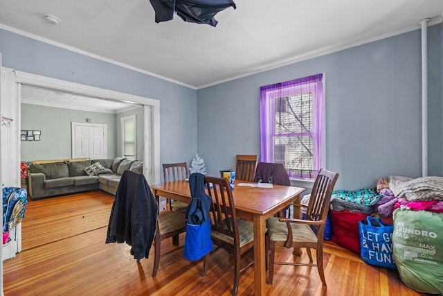 dining space featuring hardwood / wood-style floors and ornamental molding