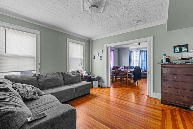 living room with wood-type flooring, ornamental molding, and wood ceiling