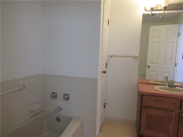 bathroom featuring vanity, a tub to relax in, and tile patterned floors