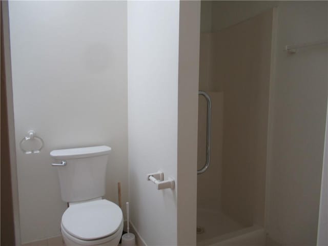 bathroom featuring a shower and toilet