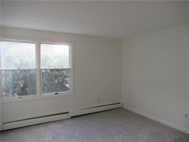 carpeted empty room with a baseboard radiator