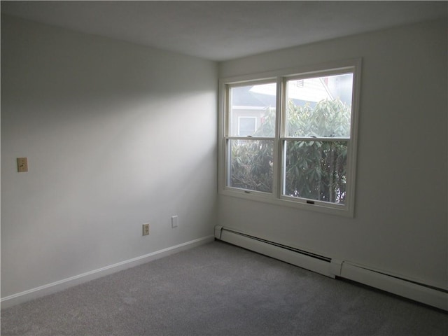 carpeted empty room with baseboard heating