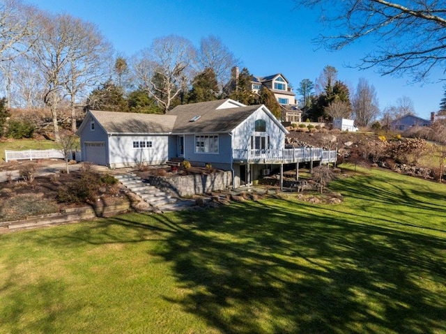 back of property featuring a garage and a lawn