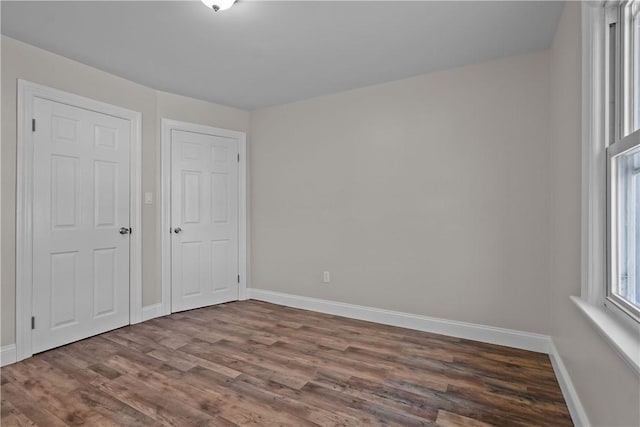 unfurnished bedroom featuring dark hardwood / wood-style flooring