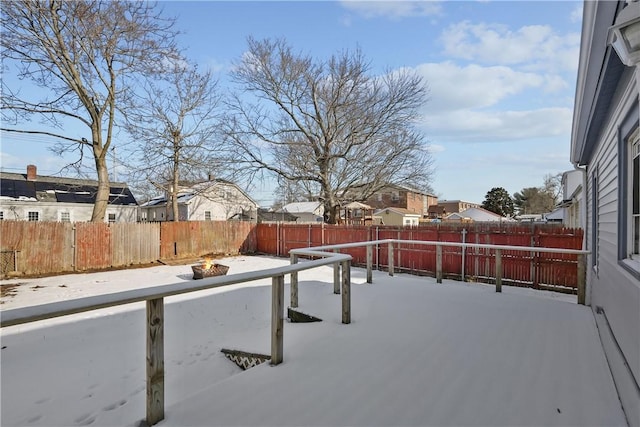 snowy yard featuring a fire pit