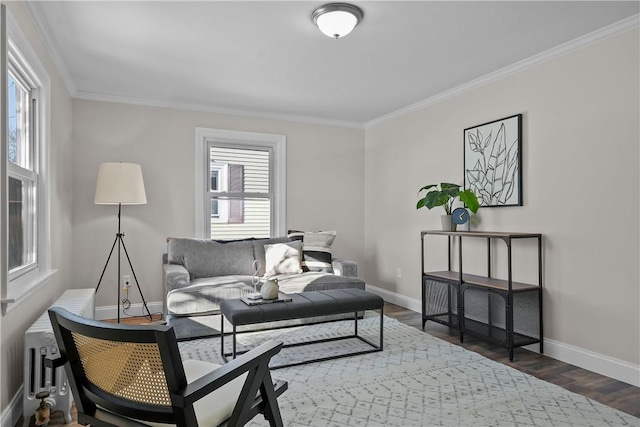 living room with crown molding, dark wood-type flooring, and a wealth of natural light