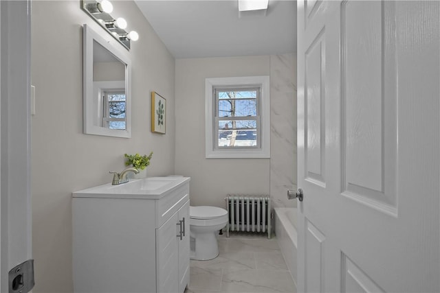 bathroom with vanity, toilet, and radiator