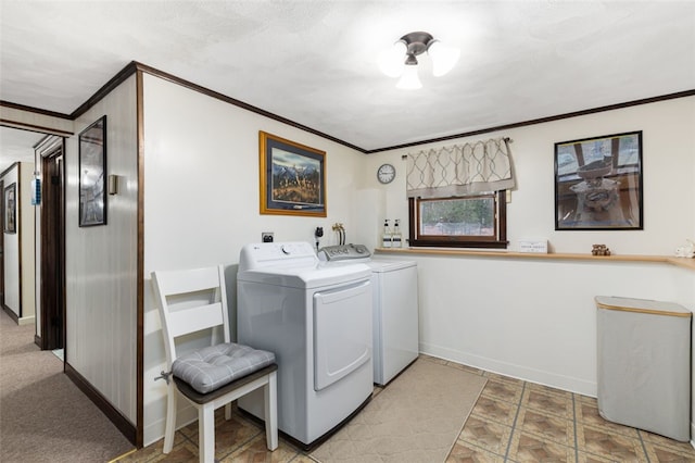 clothes washing area with crown molding and washing machine and dryer