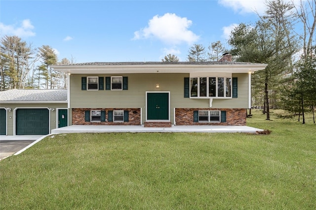 raised ranch with a garage and a front yard