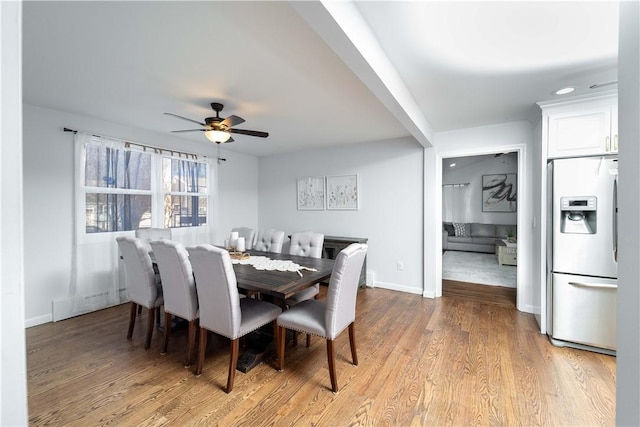 dining area with ceiling fan and light hardwood / wood-style floors