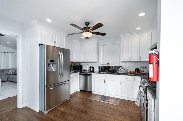 kitchen featuring stainless steel appliances, dark hardwood / wood-style floors, sink, and white cabinets