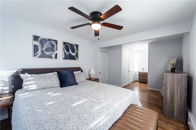 bedroom featuring ceiling fan, wood-type flooring, and connected bathroom