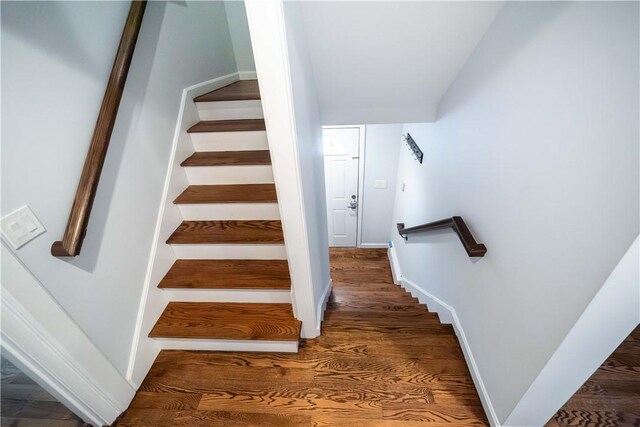 stairway with hardwood / wood-style flooring