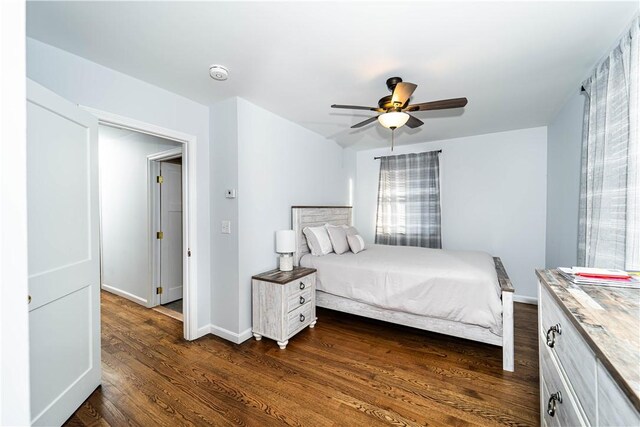 bedroom with dark hardwood / wood-style flooring and ceiling fan