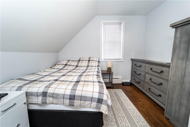 bedroom featuring vaulted ceiling, dark hardwood / wood-style floors, and baseboard heating