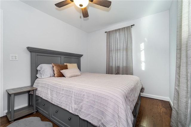 bedroom with ceiling fan and dark hardwood / wood-style flooring