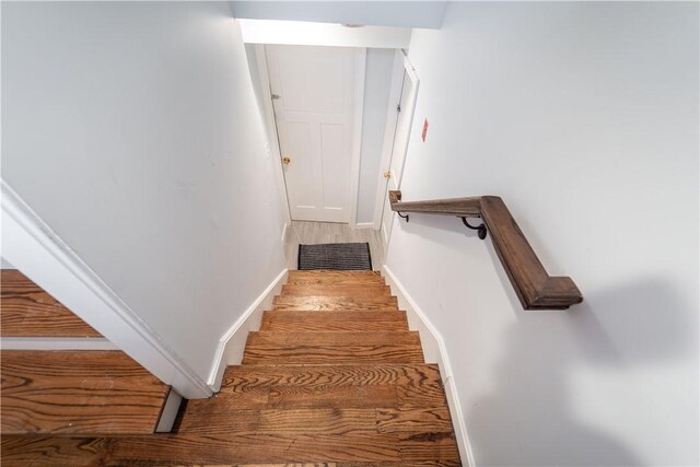 stairs featuring hardwood / wood-style flooring