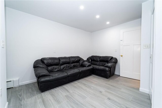 living room with light hardwood / wood-style flooring and baseboard heating