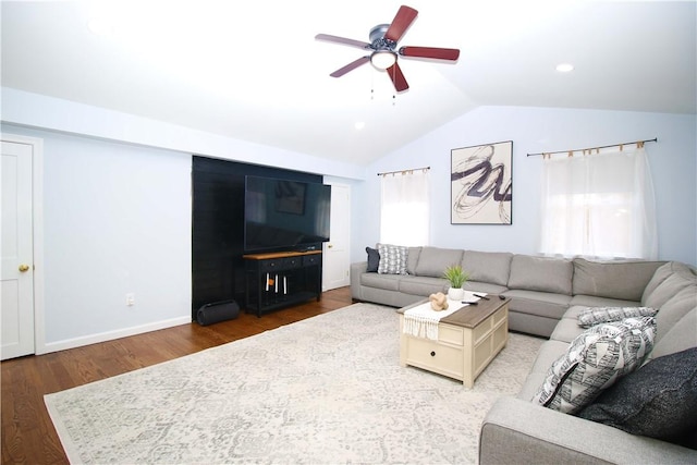 living room with ceiling fan, lofted ceiling, and hardwood / wood-style floors