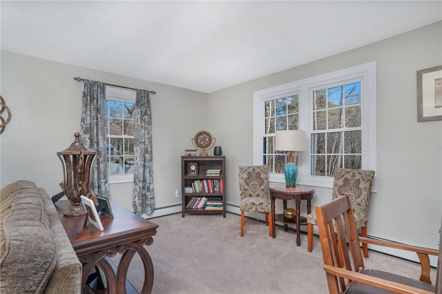 living area with light colored carpet and baseboard heating