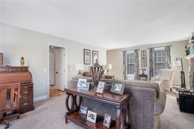 carpeted living room with a baseboard heating unit and a fireplace