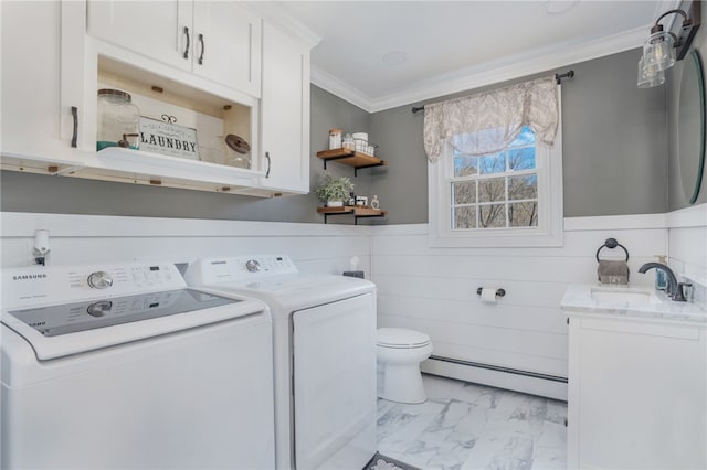 bathroom with vanity, ornamental molding, a baseboard radiator, and washing machine and dryer