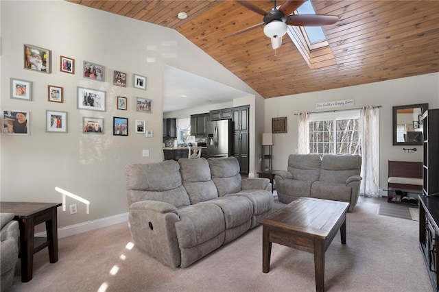 living room with wood ceiling, ceiling fan, a skylight, high vaulted ceiling, and light carpet