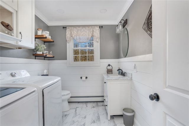 bathroom with crown molding, a baseboard heating unit, vanity, separate washer and dryer, and toilet