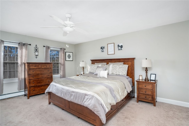 bedroom featuring light carpet, ceiling fan, and baseboard heating