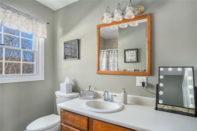 bathroom featuring vanity, toilet, and a shower with shower curtain