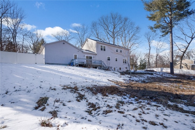 snow covered property featuring a deck